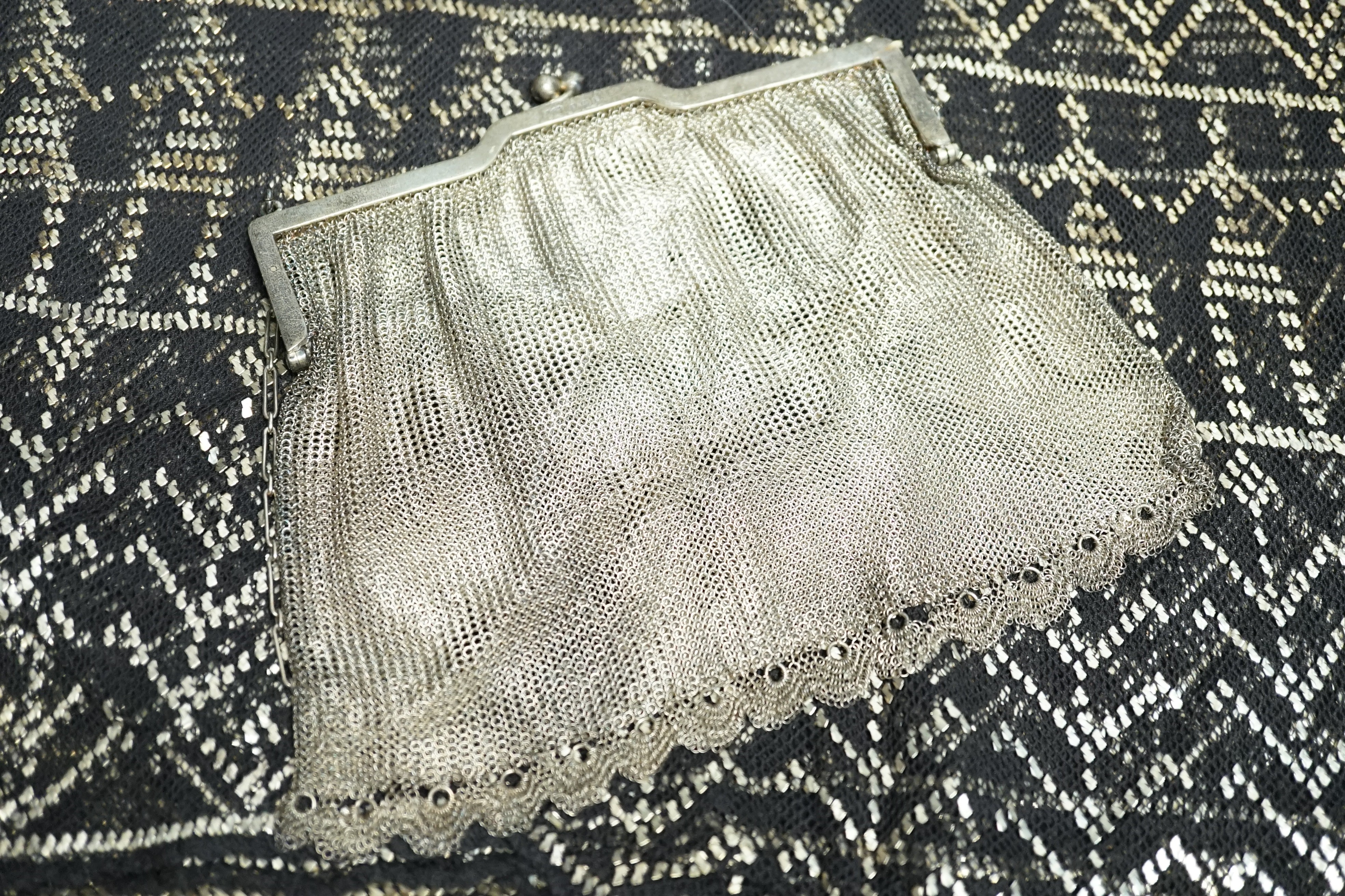 A vintage 1920's silver mesh evening bag, a black evening shawl woven with silver thread, length 240cm